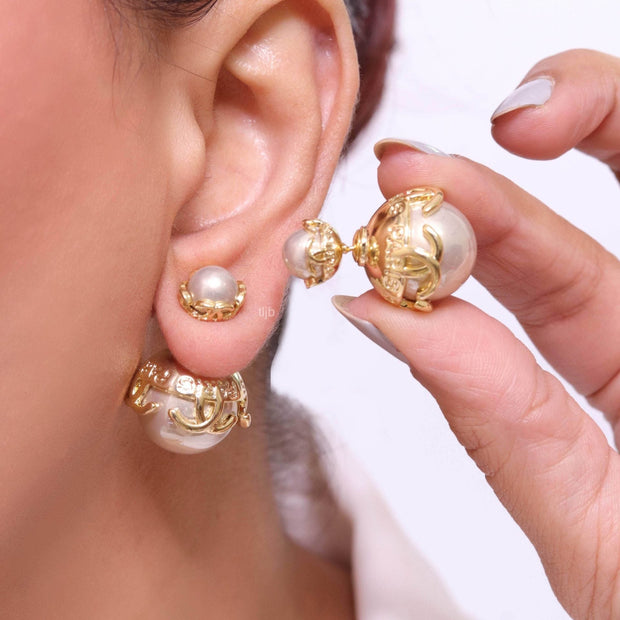 Double C beige pearl studs in gold finish