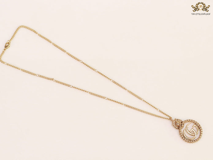 Gold plated lion face and double G initial necklace