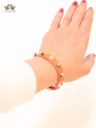Alphabet V rockstud orange bracelet