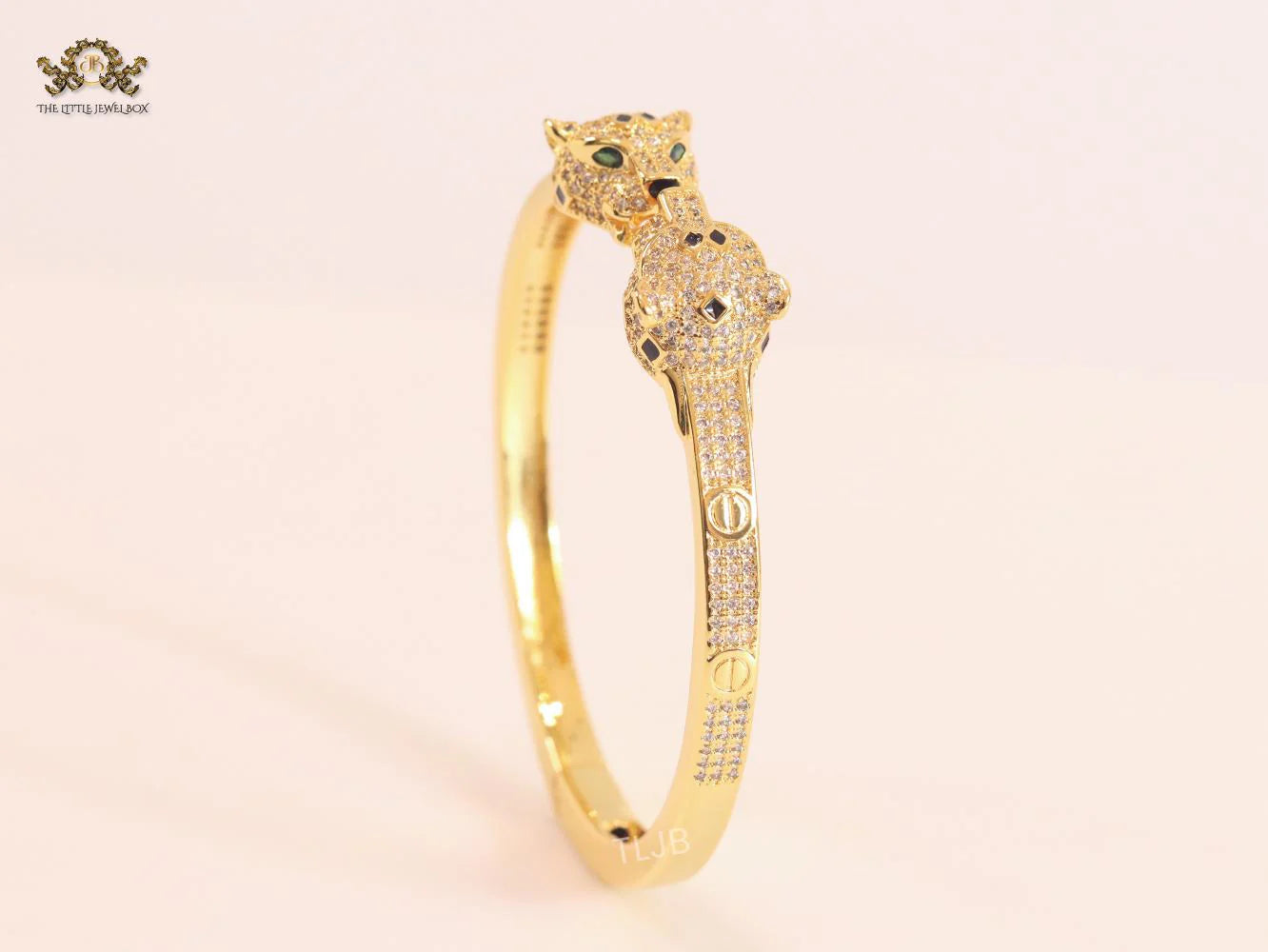 Panther heads gold and emerald bracelet
