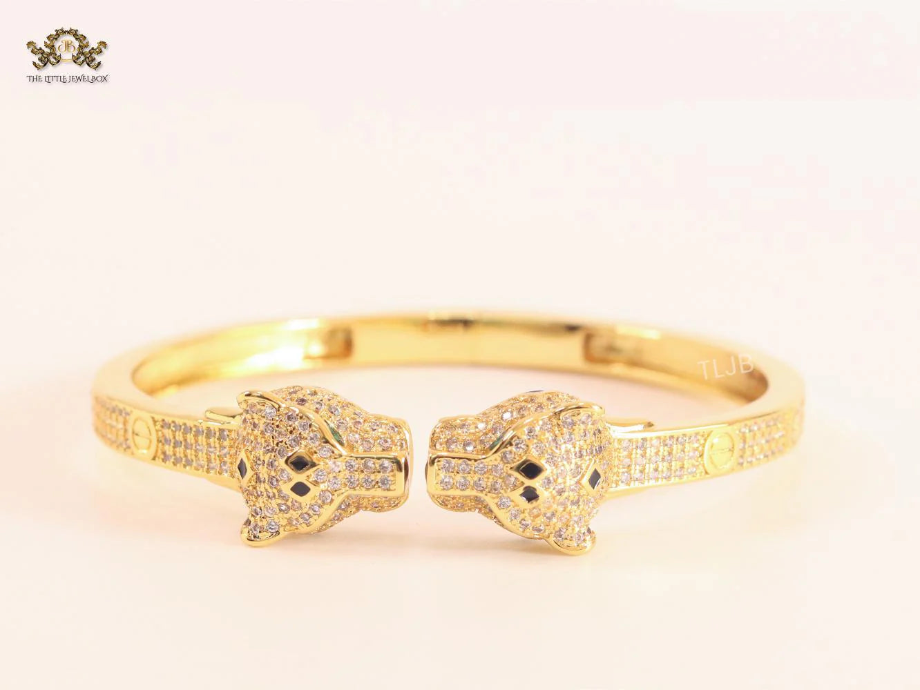 Panther heads gold and emerald bracelet