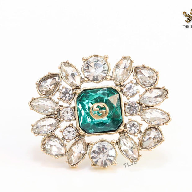 Emerald green stone and double G cz brooch