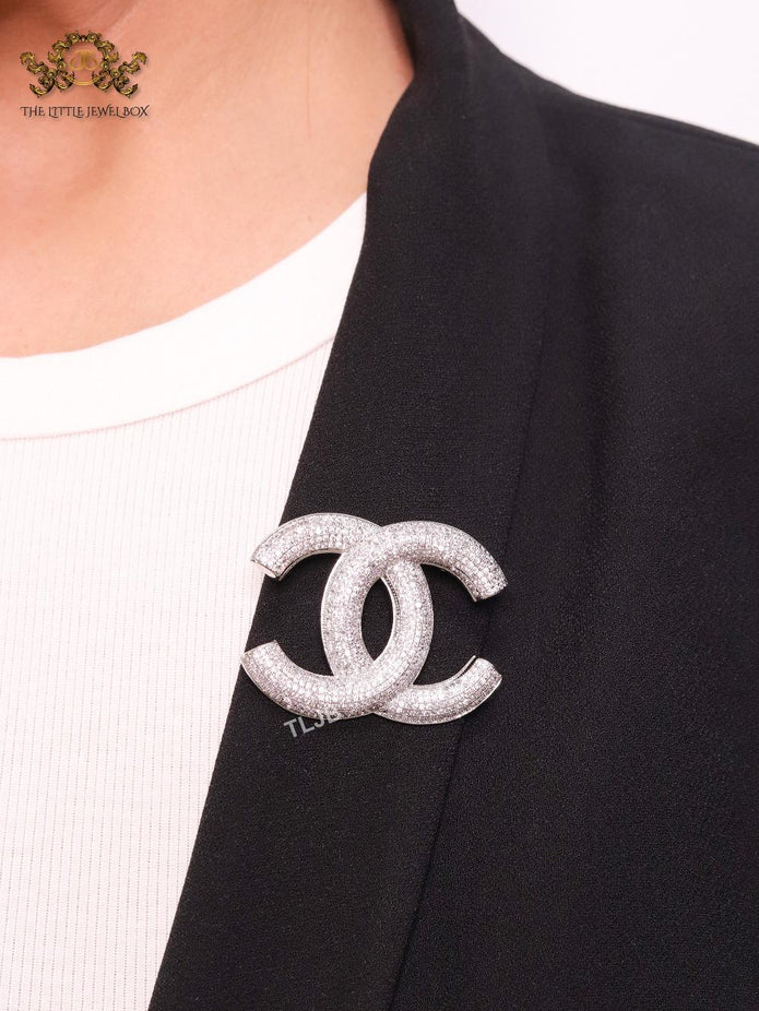 Platinum plated double C alphabet brooch with tiny cubic zirconia stones