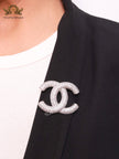 Platinum plated double C alphabet brooch with tiny cubic zirconia stones