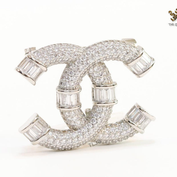 Platinum plated twin C brooch with cz baguettes