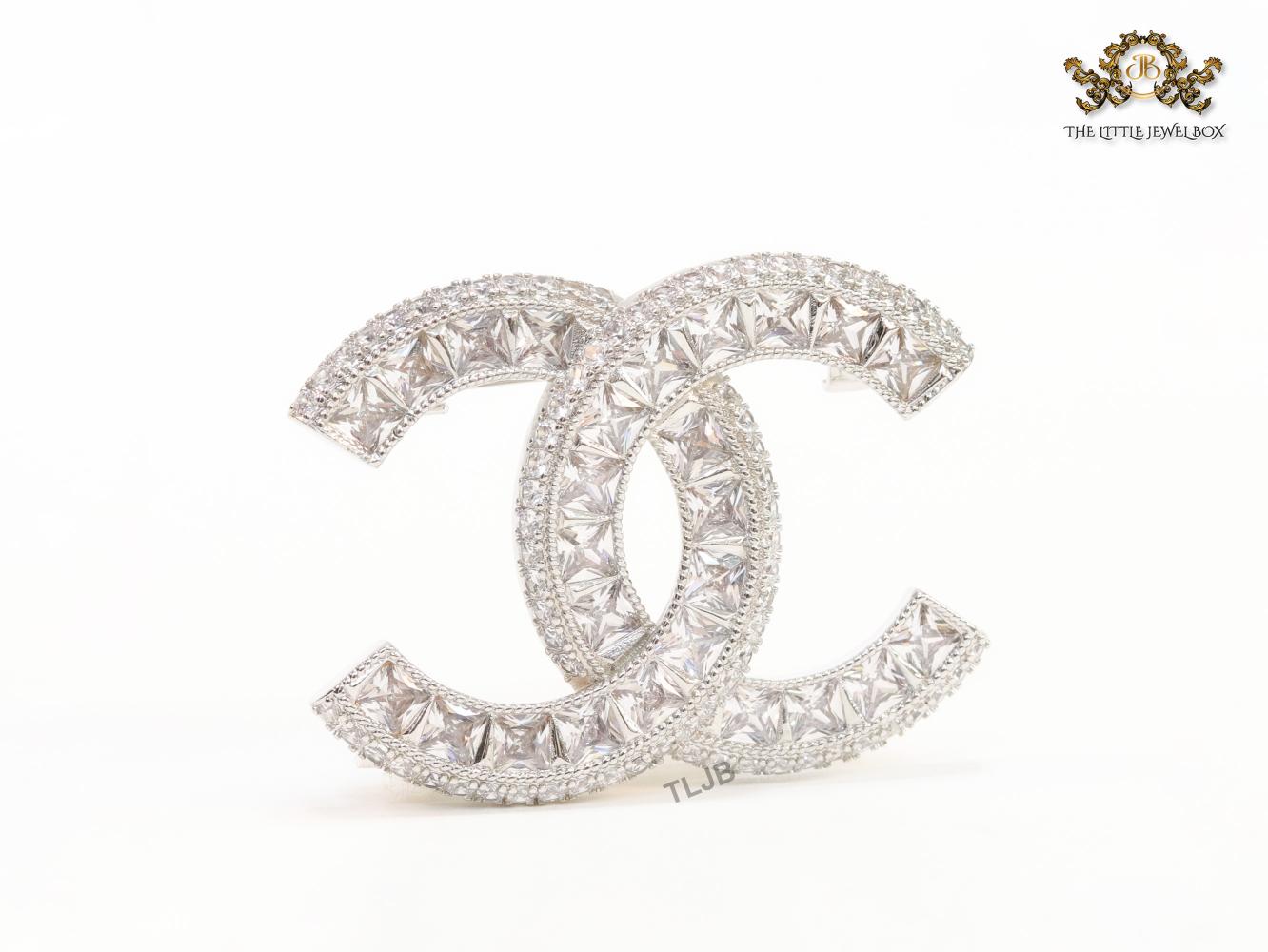Platinum plated twin C brooch with fancy cut cz