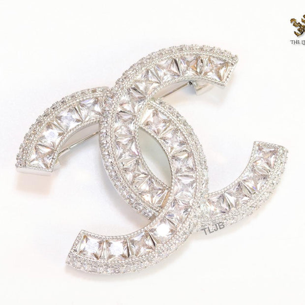 Platinum plated twin C brooch with fancy cut cz