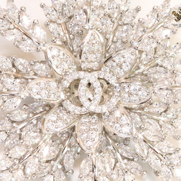 Flower and leaf brooch in platinum finish and cz