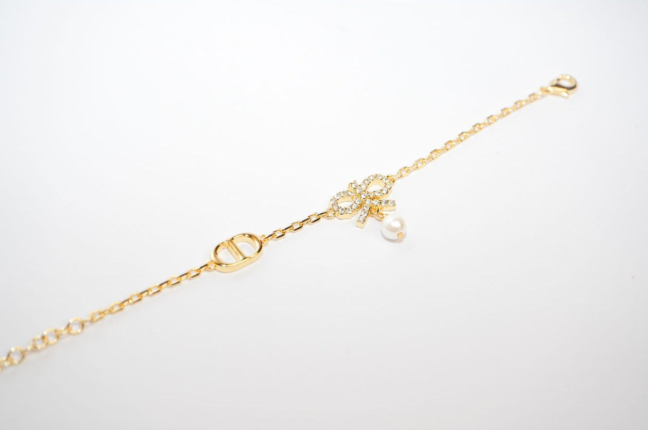 Gold Bow CZ Bracelet with Pearl Charm