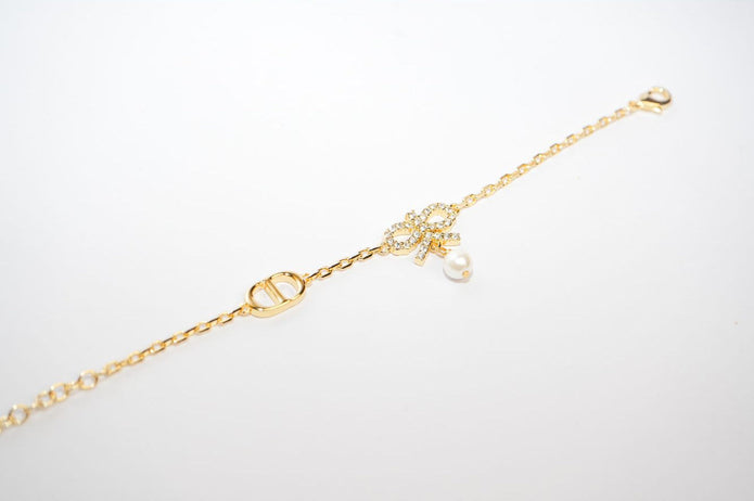 Gold Bow CZ Bracelet with Pearl Charm