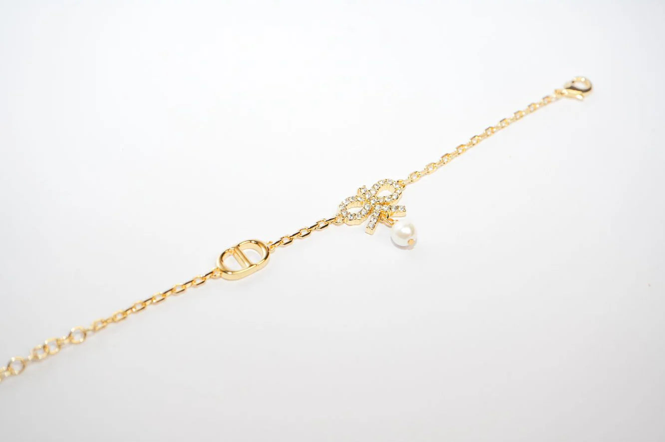 Gold Bow CZ Bracelet with Pearl Charm