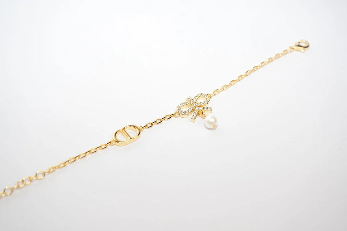 Gold Bow CZ Bracelet with Pearl Charm