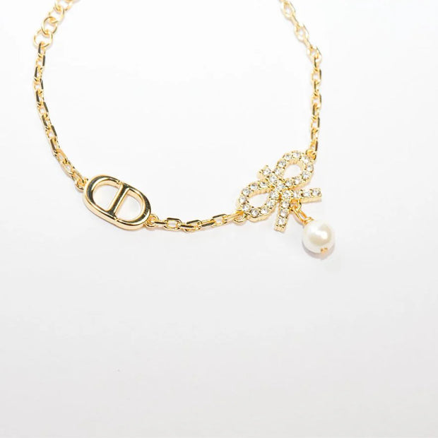 Gold Bow CZ Bracelet with Pearl Charm