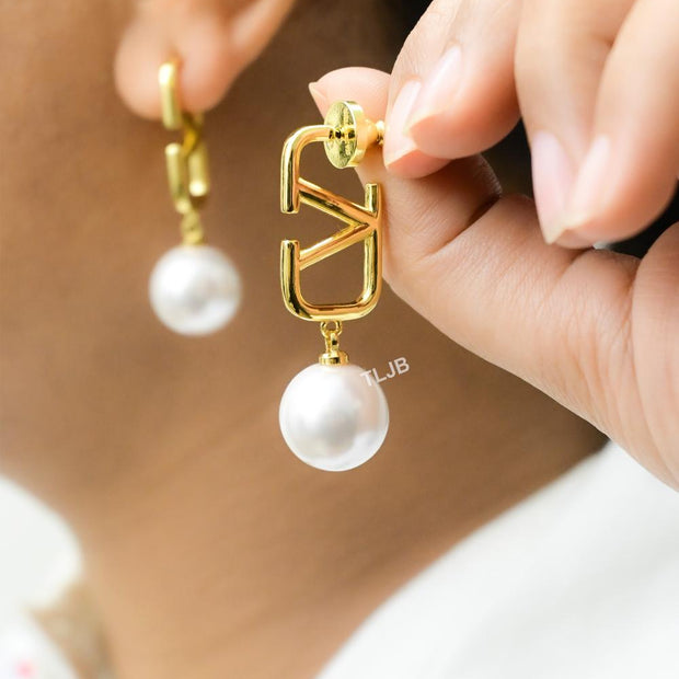 Open V and pearl earrings