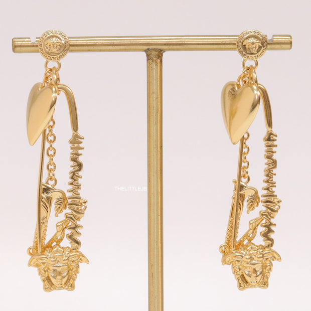 Unique golden Medusa earrings with safety pin motif