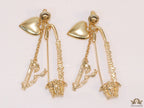 Unique golden Medusa earrings with safety pin motif
