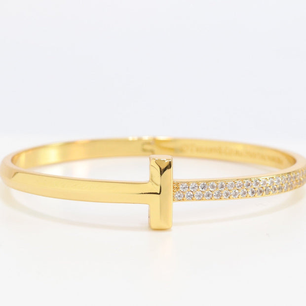 Alphabet T bracelet with half CZ in gold finish