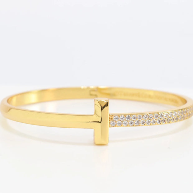 Alphabet T bracelet with half CZ in gold finish
