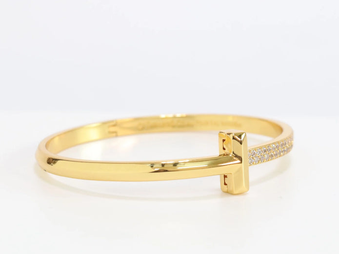 Alphabet T bracelet with half CZ in gold finish