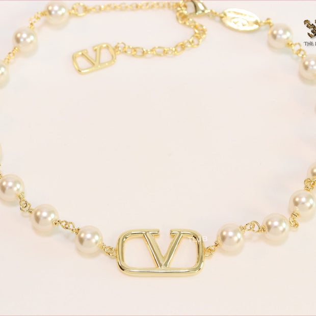 Alphabet V pearl and gold necklace