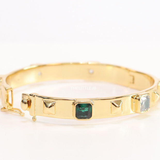 Band style bracelet in gold plating with gold plated details and multi colour stones