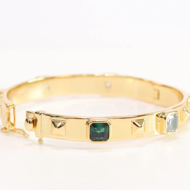 Band style bracelet in gold plating with gold plated details and multi colour stones