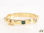 Band style bracelet in gold plating with gold plated details and multi colour stones