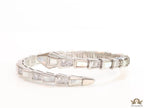 Open top platinum plated minimal serpentine bracelet with cubic zirconia stones and pearl white stones.