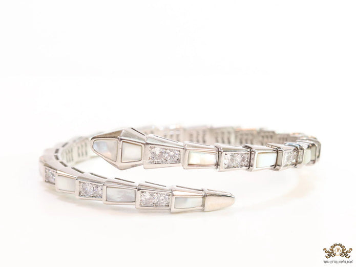 Open top platinum plated minimal snake bracelet with cubic zirconia stones and pearl white stones.