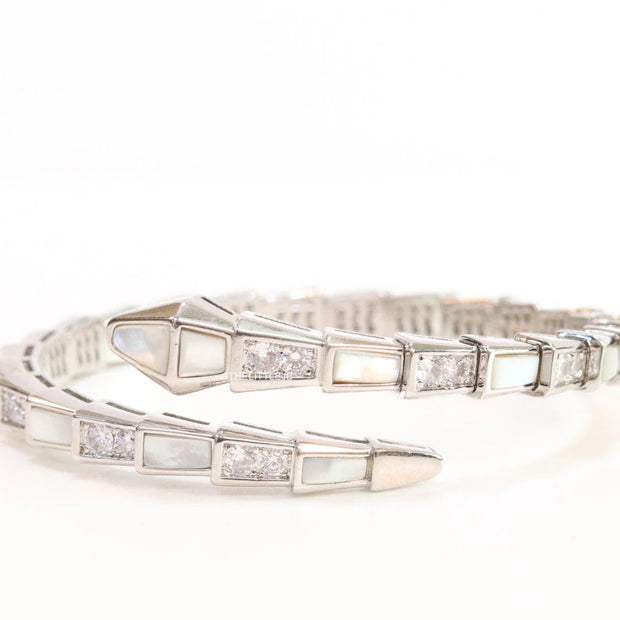 Open top platinum plated minimal snake bracelet with cubic zirconia stones and pearl white stones.