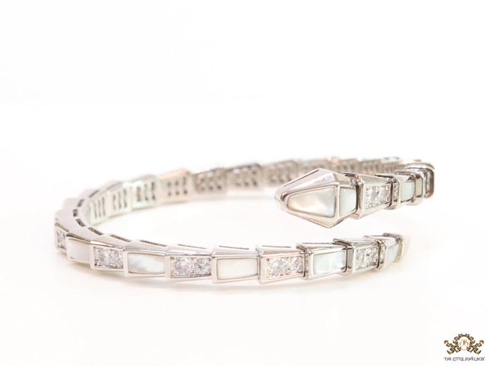 Open top platinum plated minimal snake bracelet with cubic zirconia stones and pearl white stones.