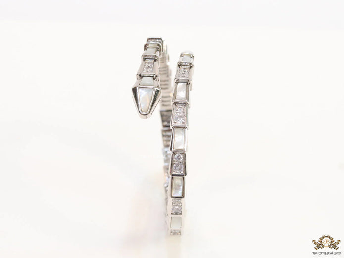 Open top platinum plated minimal snake bracelet with cubic zirconia stones and pearl white stones.