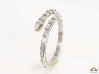 Open top platinum plated minimal serpentine bracelet with cubic zirconia stones and pearl white stones.
