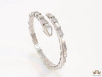 Open top platinum plated minimal snake bracelet with cubic zirconia stones and pearl white stones.