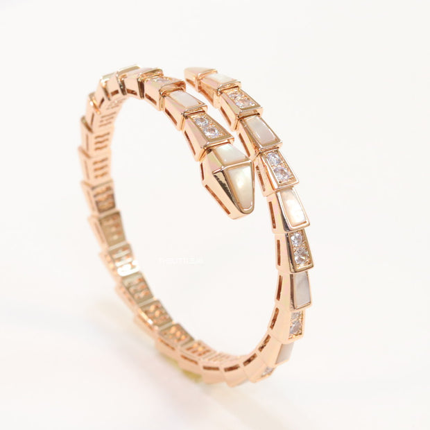 Open top rose gold plated minimal serpentine bracelet with cubic zirconia stones and pearl white stones.