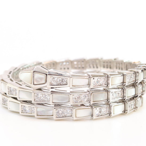 Triple line platinum plated minimal snake bracelet with cubic zirconia stones and pearl white stones.