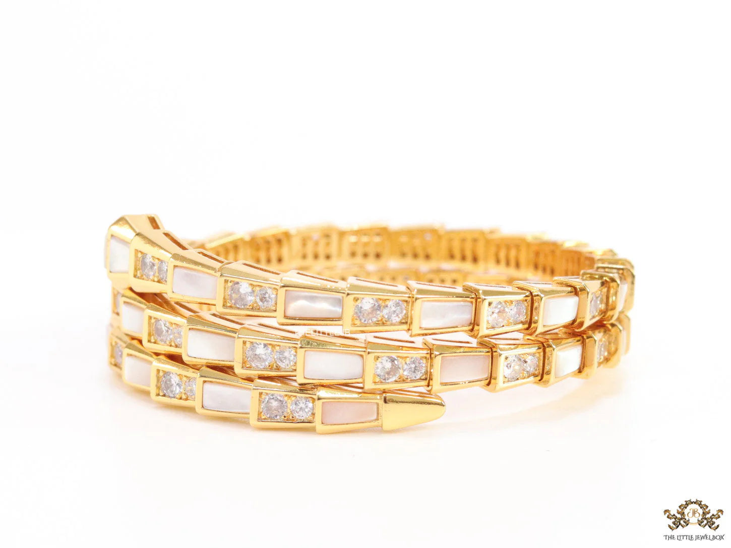 Triple line gold plated minimal snake bracelet with cubic zirconia stones and pearl white stones.