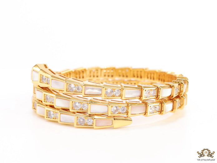 Triple line gold plated minimal snake bracelet with cubic zirconia stones and pearl white stones.