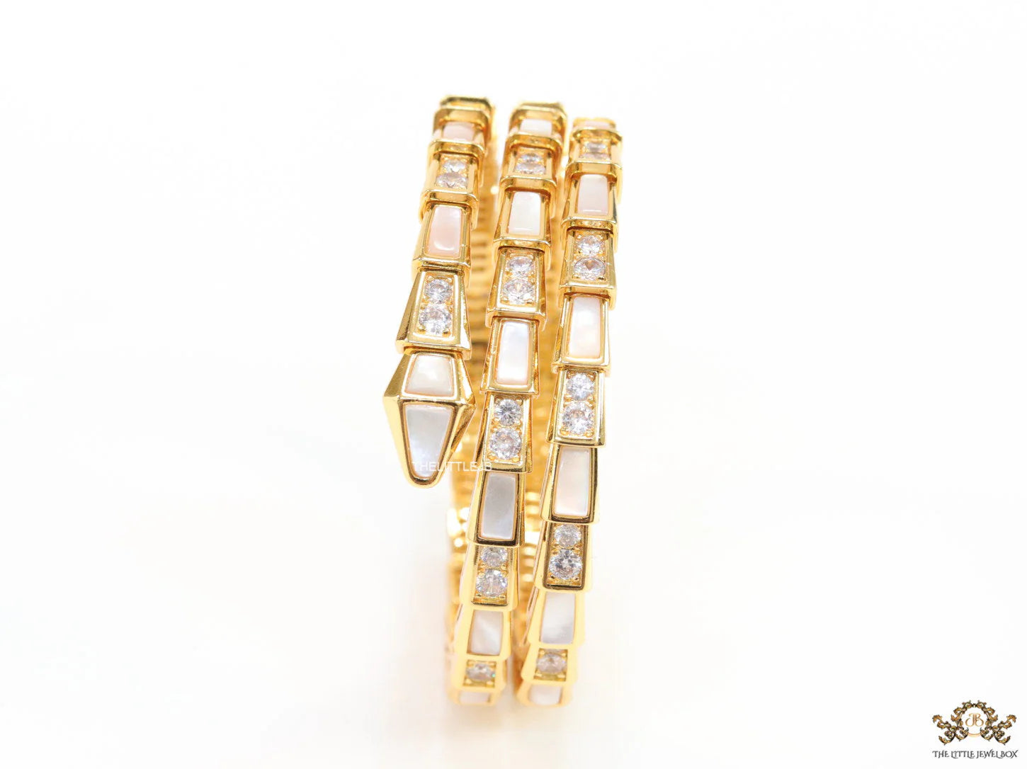 Triple line gold plated minimal snake bracelet with cubic zirconia stones and pearl white stones.