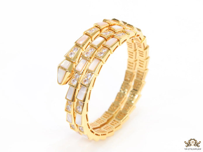 Triple line gold plated minimal snake bracelet with cubic zirconia stones and pearl white stones.