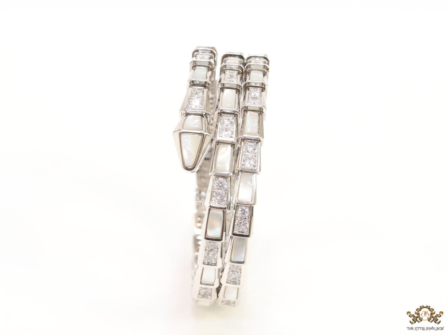 Triple line platinum plated minimal snake bracelet with cubic zirconia stones and pearl white stones.