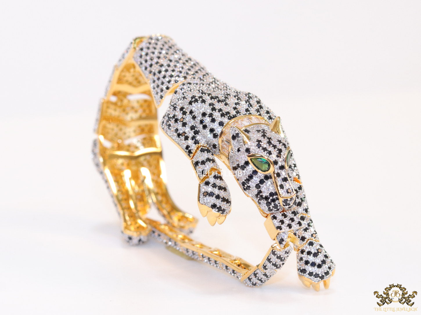 Cubic zirconia stone studded panther motif with emerald green colour stone details gold plated bracelet