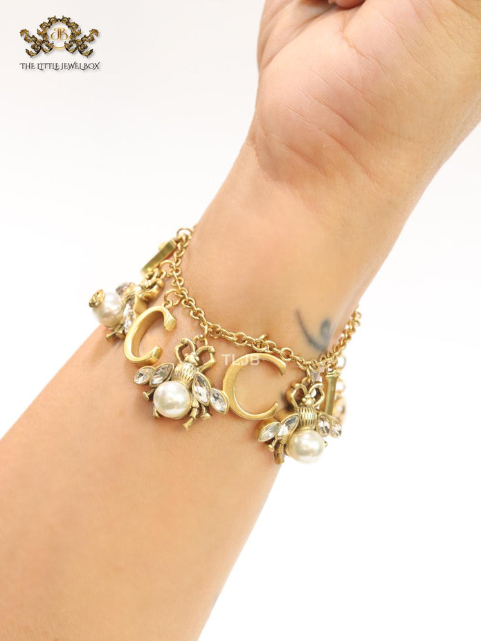 Double G bracelet with rustic charms bracelet