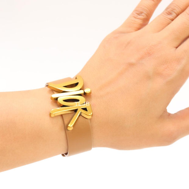Alphabet D and tan belted bracelet