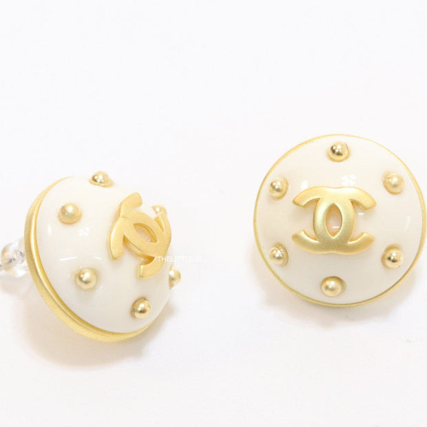 White and golden round studs with twin C motif