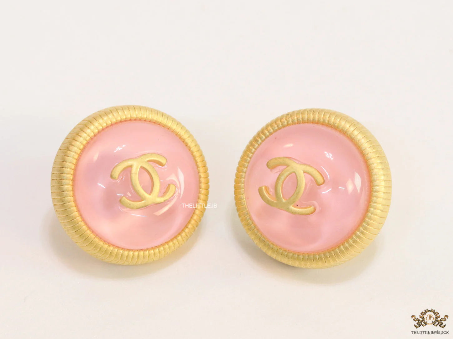 Pink and golden round studs with twin C motif