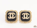 Square black and golden stud earrings with golden twin C motifs