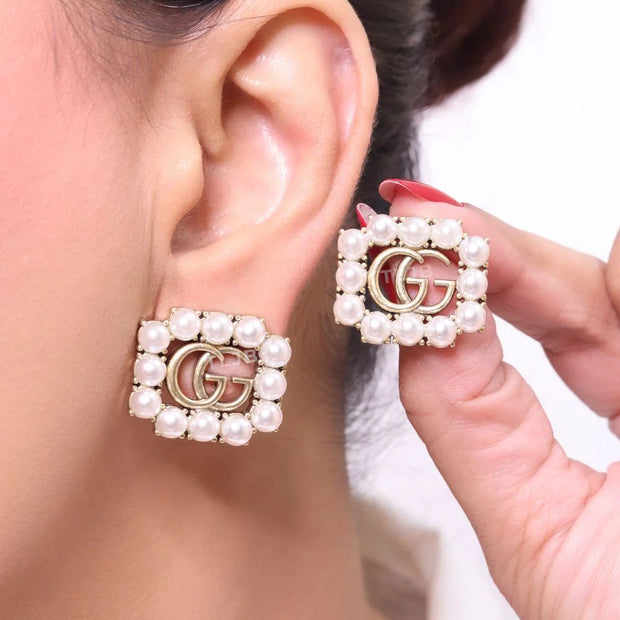 Double G rustic pearl studs