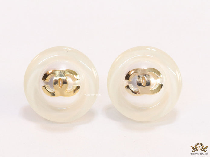 White acrylic studs with pearl and twin C motif
