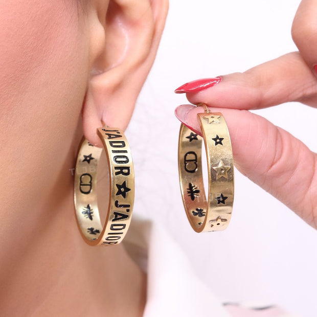 Alphabet C and D embossed on gold hoops